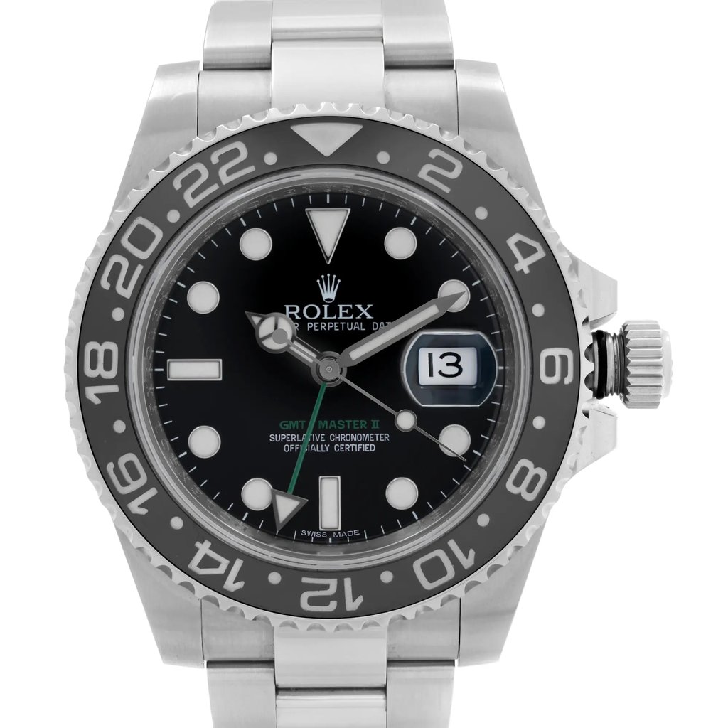 An image of a pre-owned men's luxury Rolex wristwatch. The shot is a close-up of the watch face, positioned frontally. The watch features a black dial with round indices and a black bezel. It is made of stainless steel, both the band and case. The round watch face includes features like a date indicator, luminous hands, and GMT function. The condition is classified as good.