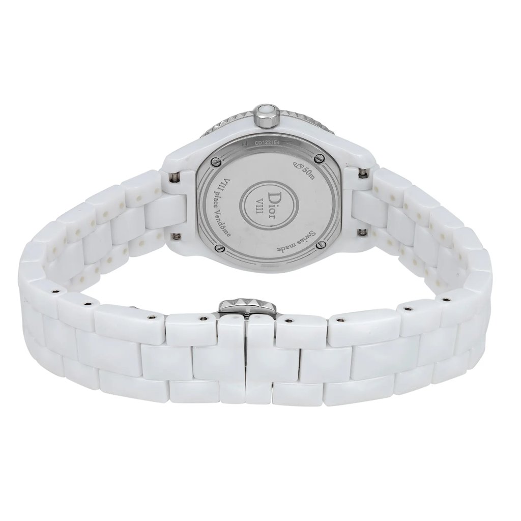 An image of a pre-owned wristwatch from the back view, showcasing the closed clasp. The watch features a white ceramic bracelet, and the focus is on the metal case back, which is centered in the image. The photo is taken from a close distance, highlighting the details of the clasp and bracelet links.