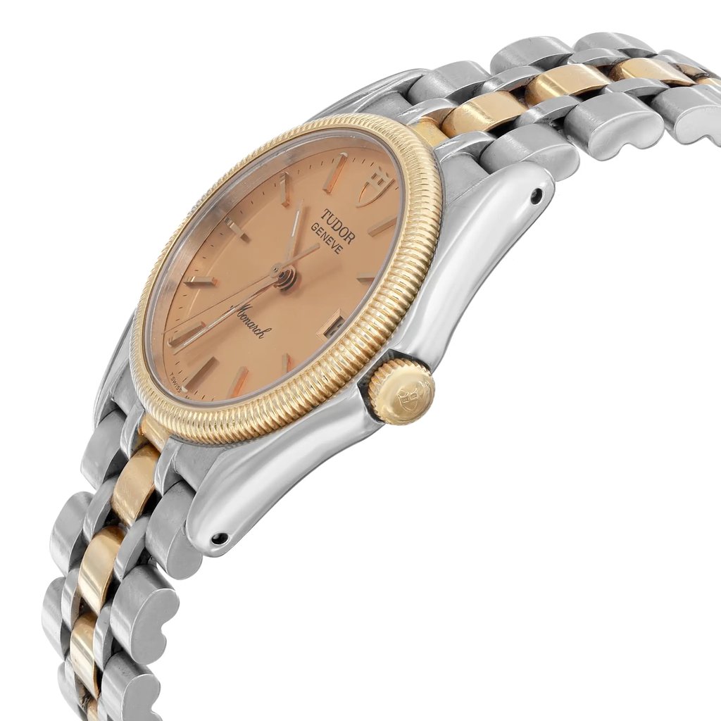 An image of a pre-owned Tudor men's wristwatch captured from a side angle at close range. The watch features a two-tone metal strap with yellow gold and steel links, a gold bezel, and a champagne dial with a date indicator and luminous hands.