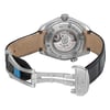 An image of a pre-owned wristwatch shown from the back view with an open clasp. The watch is positioned to display the intricate details of the movement through a transparent case back. The angle captures the watch slightly from above, providing a clear view of the leather strap and the metal clasp engraved with "OMEGA." The photo is taken at a moderate distance, focusing on the craftsmanship of the watch's back.