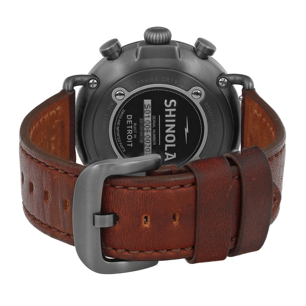 An image of a Wristwatch by Shinola. This Pre Owned item is designed for Men, featuring a Casual style. It has a Quartz movement and an Analog display with a Gray dial color. The indices include 12-Hour Dial,Arabic Numerals. The band is made of Leather and the case is made of Stainless Steel. The watch has a Round shape with a case size of 47 mm and a case thickness of 13 mm.
