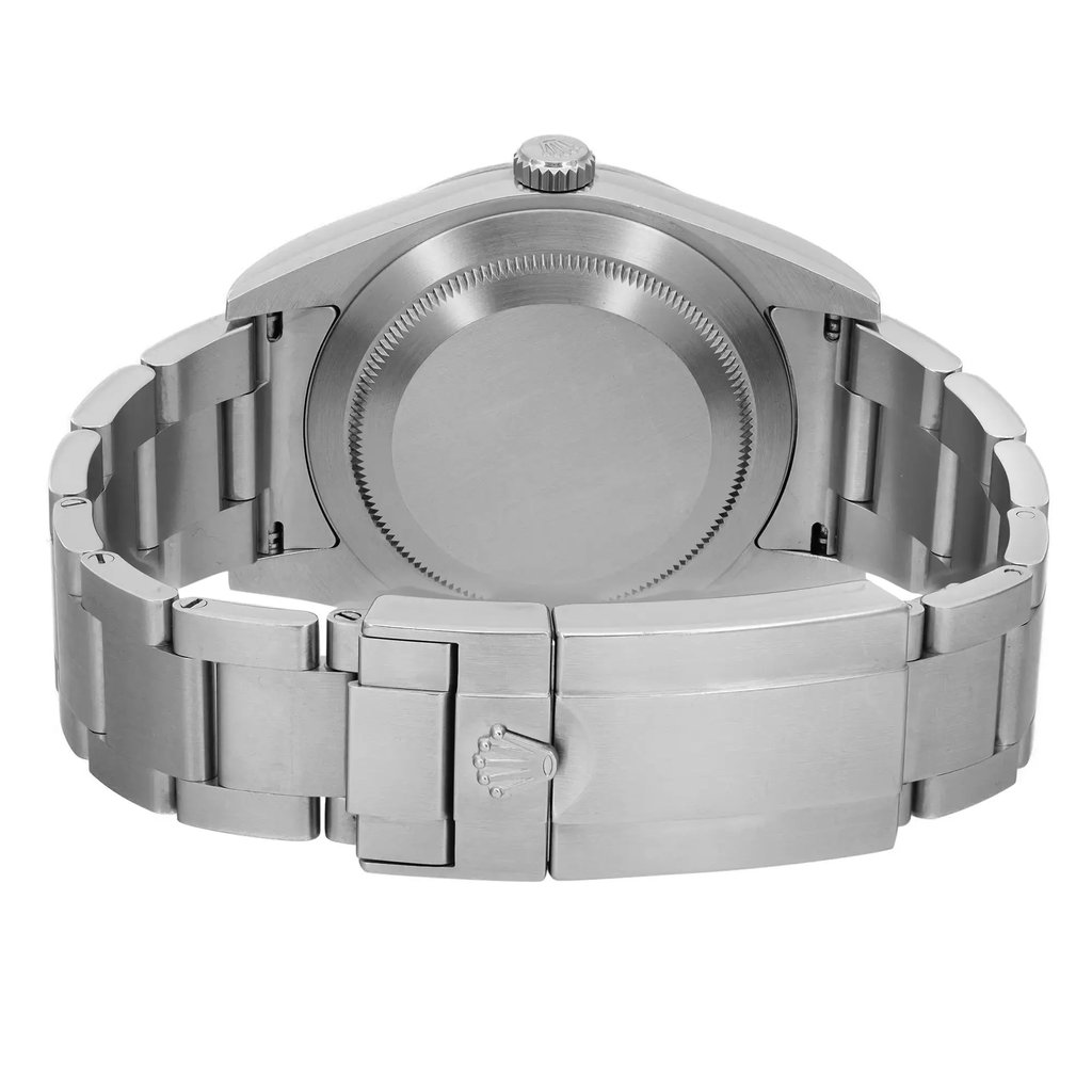 An image of a pre-owned wristwatch showing the back view with a focus on the closed clasp. The watch is positioned upright, displaying the brushed metal finish of the bracelet and the circular case back. The shot is taken from a close distance, highlighting the clasp's detailed engravings and the overall sleek design.