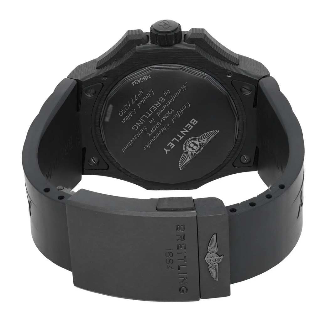 An image of a wristwatch from the back view, showing the closed clasp. The watch is positioned upright, with the focus on the clasp area and the back of the watch case. The angle highlights the detailed engravings on the back, including branding and other inscriptions. The image is taken from a close distance, capturing the display model's pristine condition.