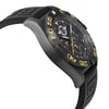 An image of a pre-owned Breitling men's wristwatch in a pilot/aviator style, presented in a side profile view opposite of the crown. The watch features a black dial and bezel, with yellow accents and numerals. It is fitted with a black rubber band and the case material is black stainless steel. The round shape of the watch is visible from this angle, showcasing its sleek design. The watch is positioned at a close distance, offering a clear view of its side profile.