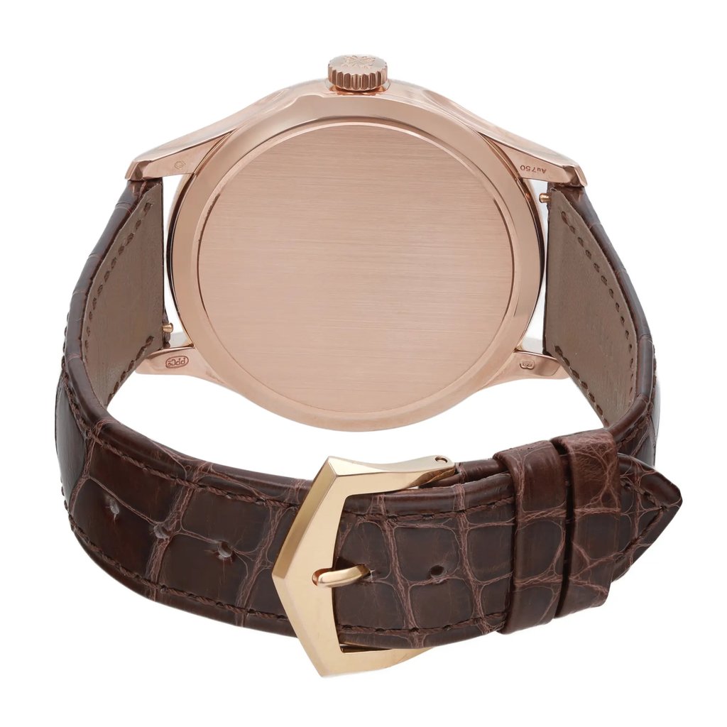 An image of a pre-owned wristwatch showcasing a back view with the clasp closed. The watch features a rose gold case and a textured brown leather strap. The photograph is taken from a close distance, highlighting the smooth finish of the watch back and the detailed pattern on the strap.