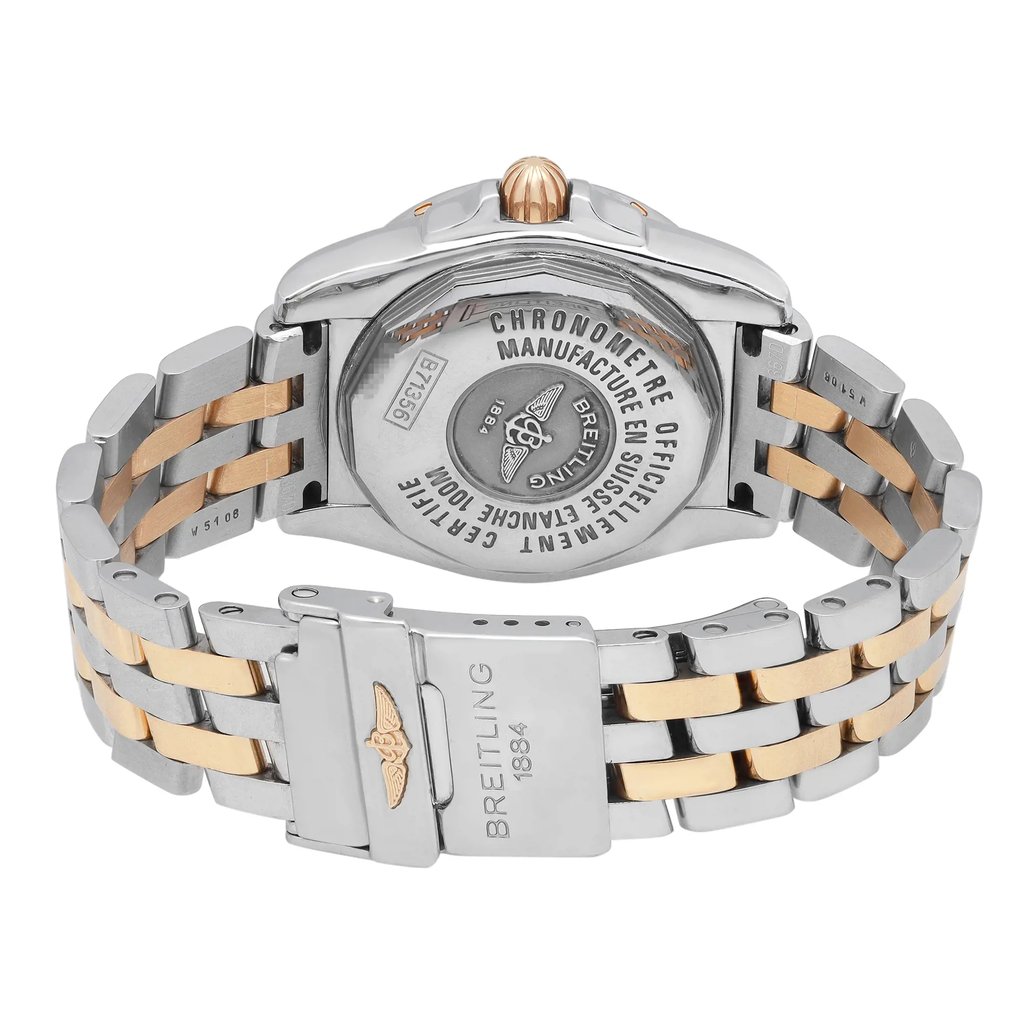 An image of a pre-owned Breitling women's wristwatch, presented from the back view at a close distance, highlighting the screwback caseback and the stainless steel and yellow gold band. The watch has a round shape, with the fold-over clasp with flip lock safety visible in the foreground, showing the Breitling logo and '1884' engraving. The watch is positioned with the clasp slightly open, angling the band in a gentle curve, allowing a view of the contrasting materials and design details. The watch is pre-owned and may show minor signs of wear.