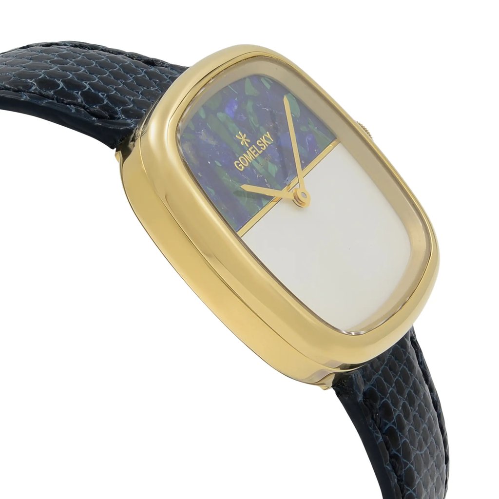 An image of a wristwatch captured from a side profile view, showcasing the opposite side of the crown. The watch features a rectangular gold-colored case with a smooth finish. Its dial is divided, with a decorative upper half and plain lower half, and gold-toned hands. The strap is black with a textured pattern, resembling a leather or reptile style. The watch is shown in an unworn condition, positioned at a slight angle, emphasizing its elegant design.