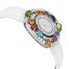 An image of a pre-owned Bvlgari women's wristwatch, taken from a slightly elevated angle showcasing the side and front of the watch. The watch features a white leather strap and a bezel adorned with various colorful gemstones, including green, orange, red, and blue. The face is round, surrounded by a circle of diamonds. The image captures the watch from a close distance, emphasizing the intricate details and vibrant colors.