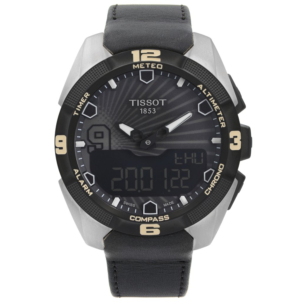 An image of a Wristwatch by Tissot. This New With Defects item is designed for Men, featuring a Sport style. It has a Quartz movement and an Analog & Digital display with a Black dial color. The indices include 12-Hour Dial,Arabic Numerals,Arrow Markers. The band is made of Leather and the case is made of Titanium. The watch has a Round shape with a case size of 45 mm and a case thickness of 13 mm.