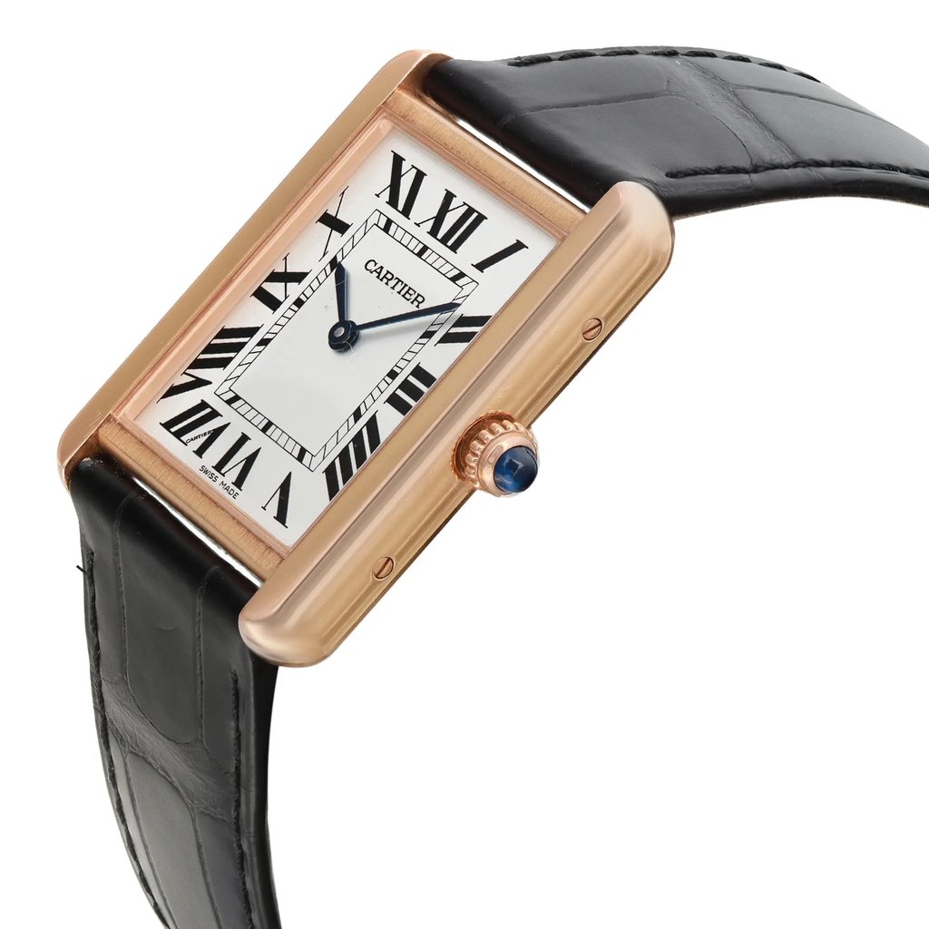 An image of a pre-owned Cartier women's luxury wristwatch with a side profile view showcasing the crown. The watch features a rectangle-shaped case and bezel in rose gold with minor signs of wear, complemented by a silver dial. The black leather band attaches to the sides of the rose gold case. The crown is adorned with a blue cabochon stone. The watch is photographed from a close distance at a slight angle to emphasize the side profile and crown details.
