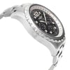 An image of a pre-owned Breitling men's luxury wristwatch, showcased in a side profile view opposite to the crown. The watch features a round shape with a steel-colored bezel and a black dial. It has a stainless steel band and case, displayed at a close angle that emphasizes the side and curvature of the timepiece. The watch is pre-owned and may show signs of wear and scratches.