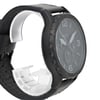 An image of a Fossil wristwatch taken from a slightly angled side view, showcasing the watch face and part of the strap. The watch is positioned close-up, highlighting its black bezel and large, easy-to-read numbers. The strap appears to be made of black leather, and the watch is new with defects. The face of the watch includes multiple dials and a date display.