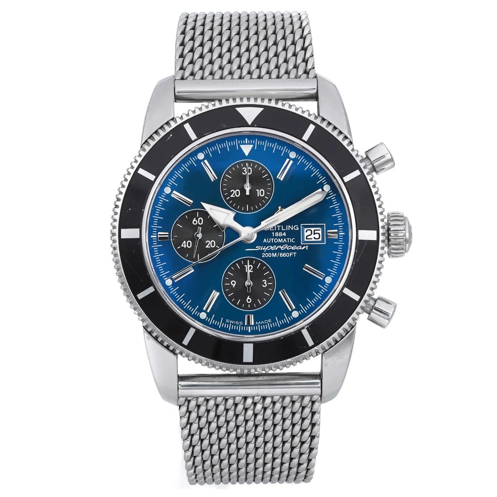 An image of a pre-owned Breitling men's wristwatch presented in a full frontal view. The watch features a round stainless steel case with minor nicks, a black bezel insert with visible scratches, and a sunburst blue dial with stick indexes for the hours. It has a chronograph function with three subdials and a date indicator at the 3 o'clock position, luminous hands, and a small seconds subdial. The stainless steel band is made of a mesh-like material. The watch is in fair condition, showing signs of wear consistent with its pre-owned status. The image is taken from a medium distance, showing the watch head-on with its entire face and part of the band visible.