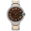 An image of a pre-owned Cartier men's wristwatch in a luxury style, presented in a full frontal view. The watch features a round stainless steel case with a steel bezel and a sunburst brown dial with Roman numerals as indices. It shows a 12-hour dial with a date window at the 3 o'clock position and is fitted with a stainless steel and 18k rose gold band, viewed from a front angle at close distance.