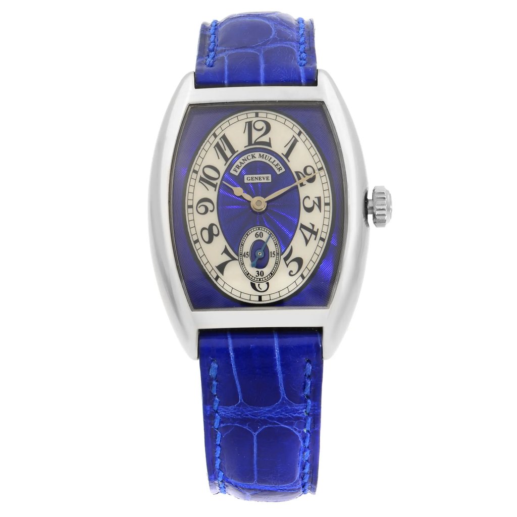 An image of a Wristwatch by Franck Muller. This New item is designed for Women, featuring a Dress/Formal,Luxury style. It has a Mechanical (Manual) movement and an Analog display with a Blue,Silver dial color. The indices include Arabic Numerals. The band is made of Leather and the case is made of White Gold. The watch has a Tonneau shape with a case size of 29 mm and a case thickness of 8 mm.