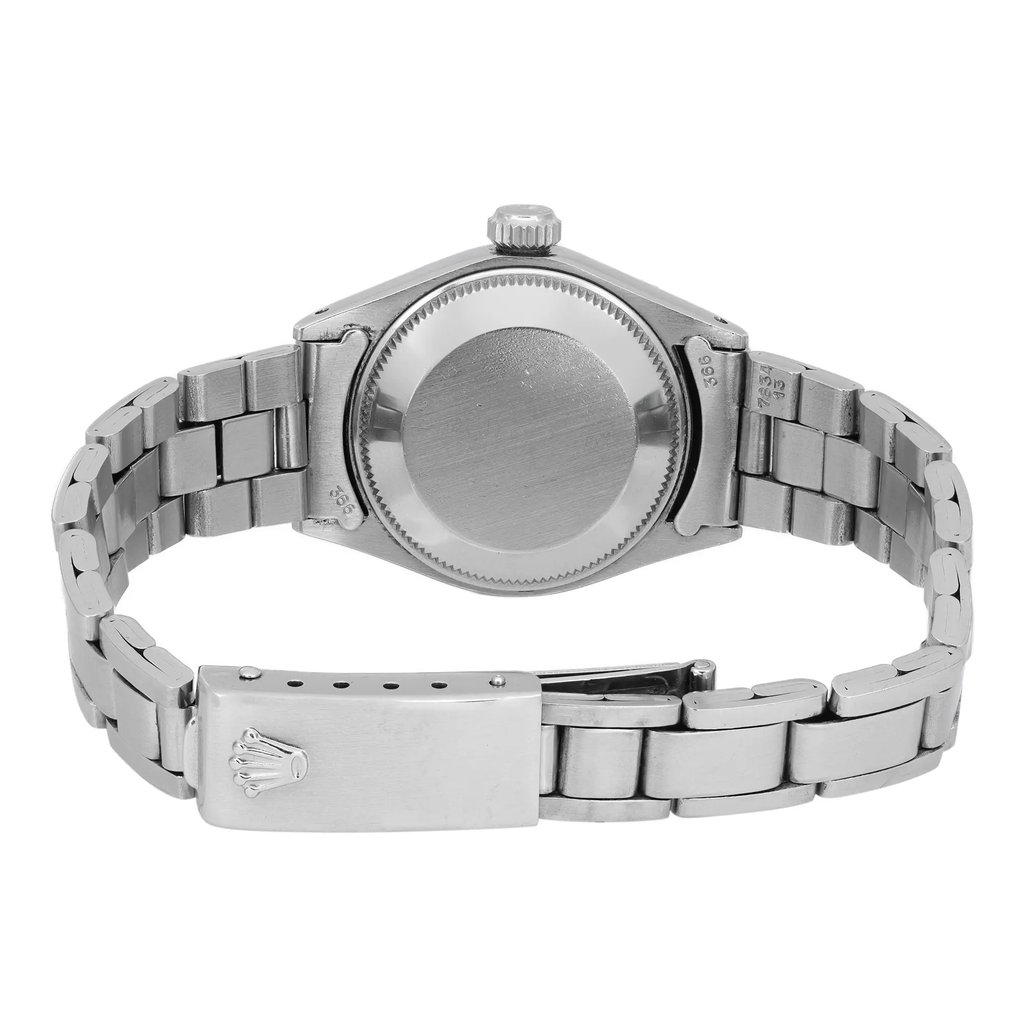 An image of a pre-owned wristwatch showing the back view. The focus is on the closed clasp and the stainless steel bracelet, with the watch case and crown visible. The angle is slightly elevated, providing a clear view of the watch's rear, at a close distance.