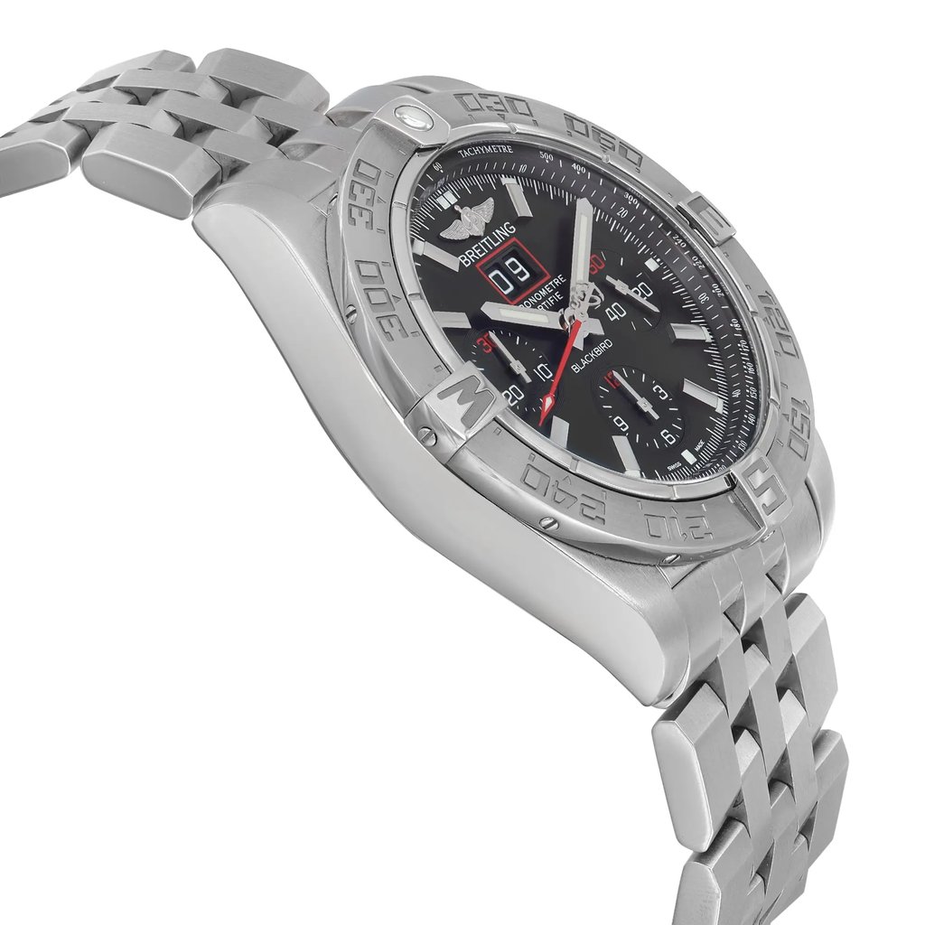 An image of a pre-owned Breitling men's pilot/aviator wristwatch, presented in a side profile view opposite of the crown, depicting its round shape and stainless steel case and band. The watch features a black dial with luminous hands, a date indicator, a chronograph, and a small seconds subdial, all set within a gray bezel. The angle provides a clear view of the watch's design and contours, shot from a medium distance, showcasing the intricate details and craftsmanship.