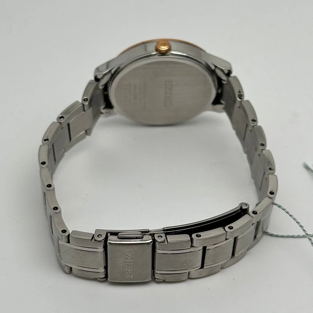 An image of a Wristwatch by Seiko. This Display Model item is designed for Women, featuring a Casual style. It has a Quartz movement and an Analog display with a Brown dial color. The indices include 12-Hour Dial,Stick Indexes. The band is made of Stainless Steel and the case is made of Stainless Steel. The watch has a Round shape with a case size of 29 mm and a case thickness of 8 mm.