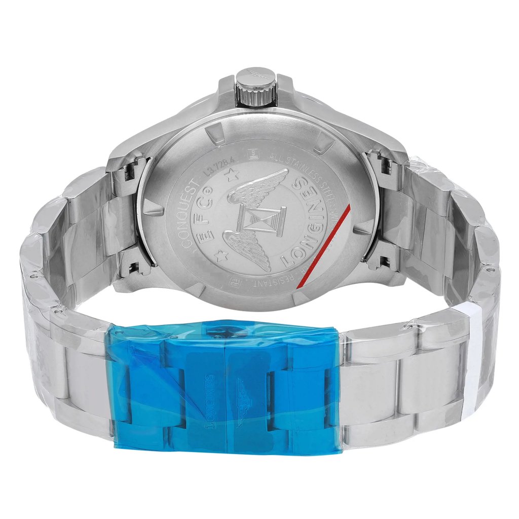 An image of a wristwatch taken from the back view, showcasing an open clasp. The watch is positioned upright, with a clear focus on the stainless steel case back, which features engraved details. The camera angle is slightly elevated, capturing the full length of the bracelet and clasp, with a blue protective film partially covering the clasp. The image is taken at a close distance, highlighting the watch's pristine condition as a display model.