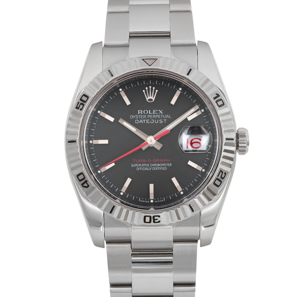 An image of a pre-owned wristwatch taken from a front close-up angle, focusing on the watch face. The dial is black with silver hour markers and hands, featuring a date window displaying the number 16. The bezel has engraved numerals, and the watch is attached to a metallic bracelet.