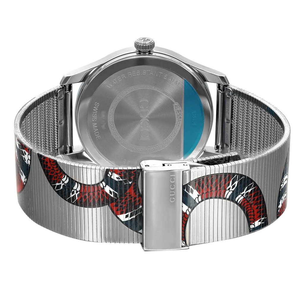An image of an unworn Gucci unisex wristwatch with a stainless steel case and band. The watch is shown from the back view with a snap caseback and the fold-over clasp is in the closed position. The band displays animal pattern. The angle of the shot is a direct back view with a focus on the caseback, clasp, and part of the band. The distance is close-up, providing clear visibility of the watch's details, including branding and the texture of the metal band.