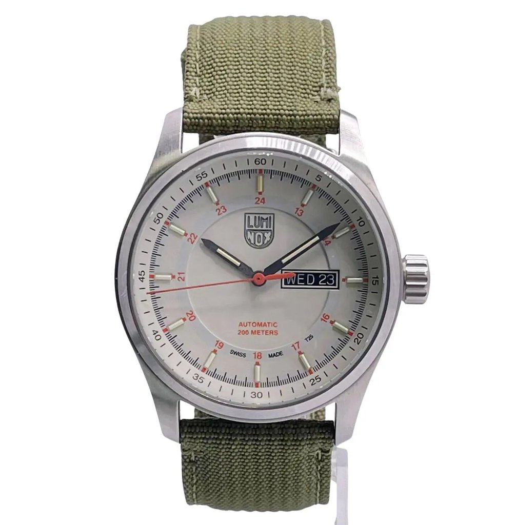 An image of a Wristwatch by Luminox. This Pre Owned item is designed for Men, featuring a Casual,Classic,Diver,Military style. It has a Mechanical (Automatic) movement and an Analog display with a Beige dial color. The indices include 12-Hour Dial,Stick Indexes. The band is made of Nylon and the case is made of Stainless Steel. The watch has a Round shape with a case size of 44 mm and a case thickness of 14 mm.