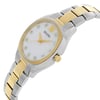 An image of a pre-owned Bulova women's dress/formal wristwatch in a side profile view with the crown visible. The watch features a mother of pearl dial with a matching dial pattern, gold-tone bezel, stainless steel band, and tonneau/barrel-shaped stainless steel case. The photograph is taken at a close distance, highlighting the side angle of the watch to showcase its design and condition.