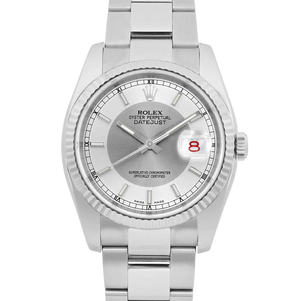 An image of a pre-owned Rolex men's wristwatch, viewed from the front at a close distance. The watch features a tuxedo silver dial with a date indicator at the 3 o'clock position, highlighted by a magnifying lens. The luminous hands are positioned at approximately 10:10, and the watch is encased in a stainless steel bracelet.