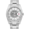 An image of a pre-owned Rolex men's wristwatch, viewed from the front at a close distance. The watch features a tuxedo silver dial with a date indicator at the 3 o'clock position, highlighted by a magnifying lens. The luminous hands are positioned at approximately 10:10, and the watch is encased in a stainless steel bracelet.