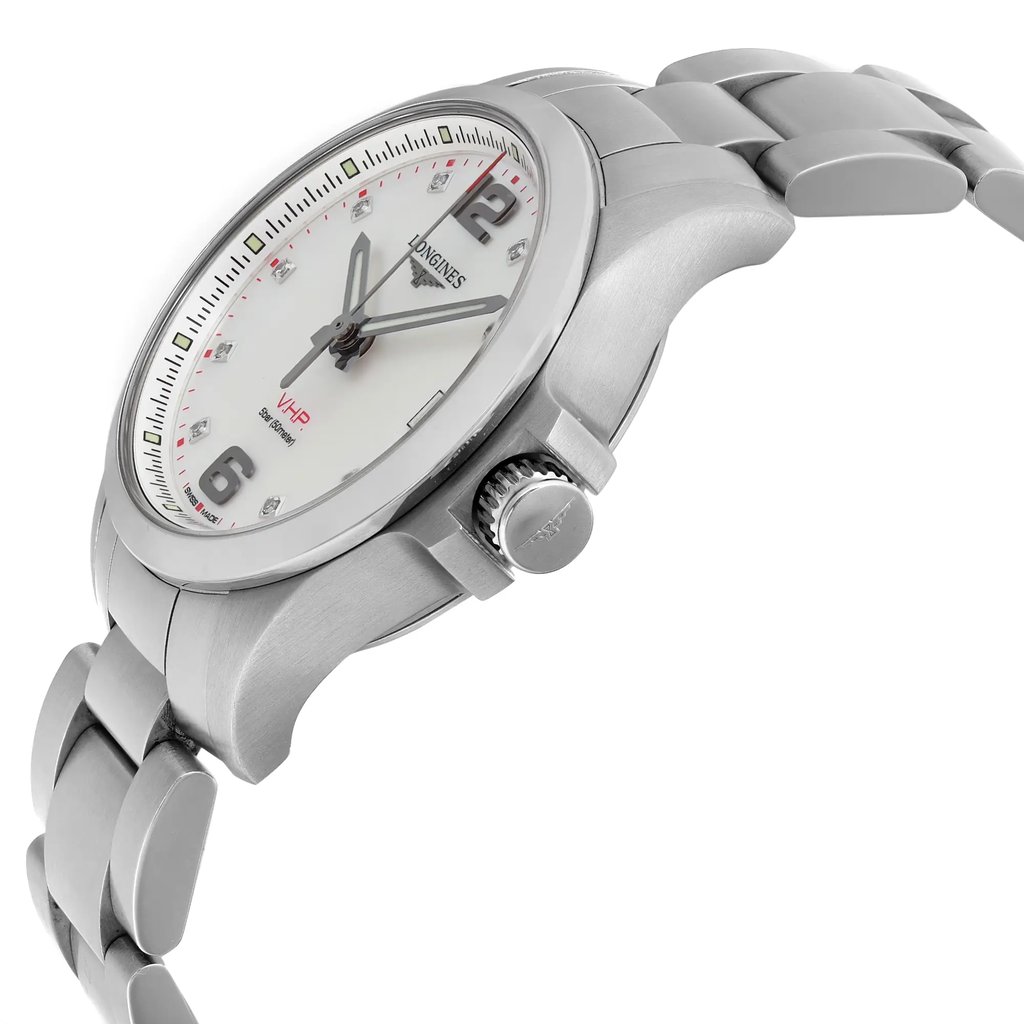 An image of a pre-owned Longines women's wristwatch in like-new condition, showcased in a side profile view that prominently displays the crown. The watch has a round stainless steel case and band in a casual style, with a mother of pearl dial pattern on a white background. The bezel is a contrasting gray, viewed at an angle that conveys the watch's dimensions and design details. The distance from the camera provides a clear and detailed view of the timepiece, including the elegant hour markers and hands.