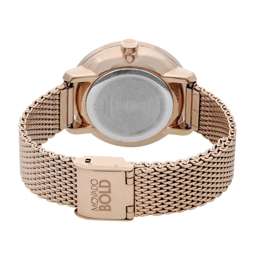 An image of a pre-owned wristwatch showing the back view at a close angle. The focus is on the closed clasp and the metallic mesh strap. The watch has a round case with a smooth back, and the brand name is visible on the clasp. The image captures the watch from a slightly elevated rear perspective.