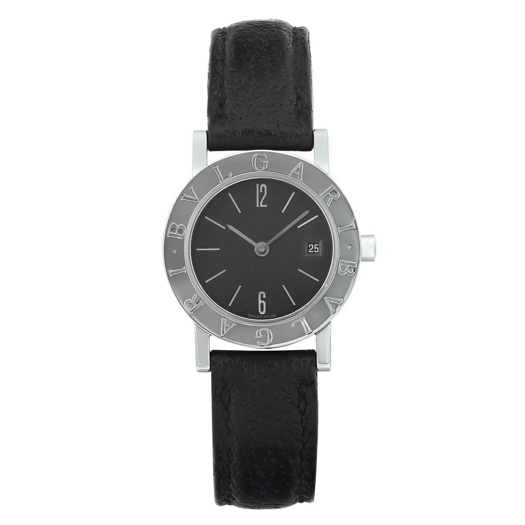  This is an image of a pre-owned, women's Bvlgari Bvlgari 26mm wristwatch, taken from a straight-on angle. The watch showcases a black leather strap and a round silver steel bezel engraved with the brand name. The black dial features silver hour markers and hands, along with a date indicator at the 3 o'clock position. The wristwatch is positioned vertically and photographed at a close distance to highlight its intricate details. There are minor dings on the case and visible signs of wear on the bands. Minor blemishes may occur during handling and shipping, and it comes with an aftermarket buckle.