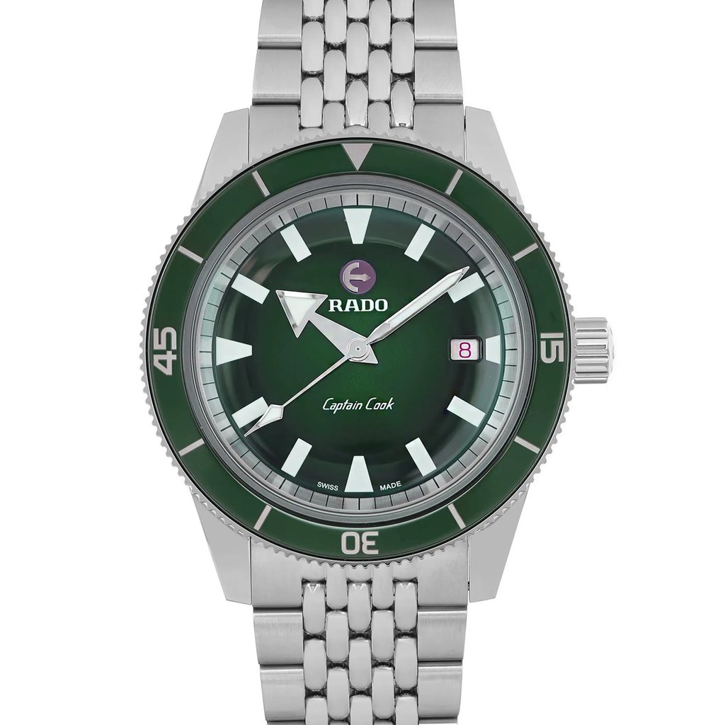 An image of an unworn men's Rado wristwatch, showing a front close-up of the watch face. The round dial and bezel are both green, with stick indexes marking the 12-hour dial. The stainless steel band and case add a sleek touch to its casual style. The watch is positioned directly facing the viewer, highlighting its detailed design.