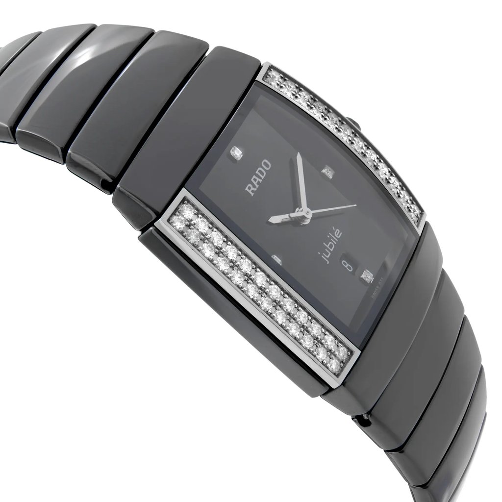 An image of a pre-owned wristwatch viewed from the side profile, opposite the crown. The watch features a sleek, black band with a rectangular face adorned with diamond accents on the sides. The angle captures the watch at a slight tilt, showcasing its elegant design. The photograph is taken from a medium distance, highlighting the details of the watch face and bracelet.