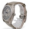 An image of a pre-owned Vacheron Constantin men's wristwatch displayed at a slight angle, showcasing the detailed watch face and luminous hands. The watch is positioned upright on a transparent stand, with its side and partially visible strap in view. The angle emphasizes the intricate design of the dial and the unique features of the timepiece, captured from a close distance.