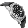 An image of a pre-owned wristwatch captured from a side profile view, opposite the crown. The watch features a silver-toned case with a diamond-studded bezel and a black strap. The angle highlights the intricate design of the black dial with large, stylized white numerals. The photo is taken at a close distance to emphasize the watch's details and craftsmanship.