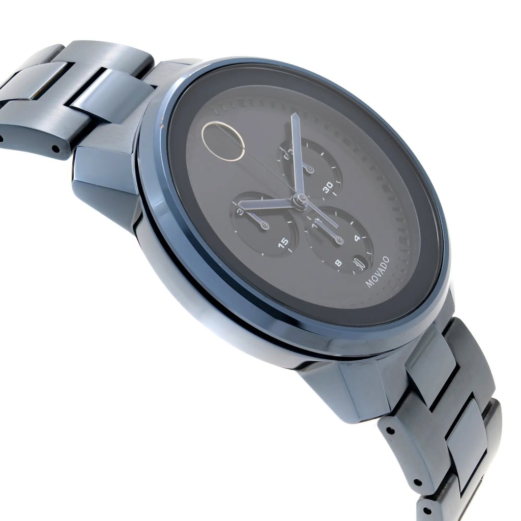 An image of a wristwatch taken from a side profile view, opposite the crown. The watch has a metallic finish and features a dark face with three sub-dials. The bracelet is composed of polished metal links. The image is captured at a close angle, showcasing the details of the watch's design and condition.