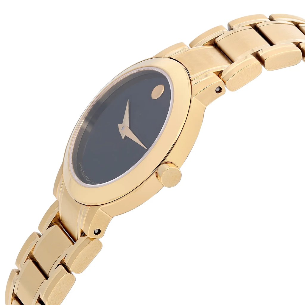 An image of a wristwatch shown from a side profile view. The crown is prominently visible on the right side of the watch case. The watch features a gold-toned metal strap and a dark dial, with sleek hands and a minimalist design. The unworn condition of the watch is evident from the polished finish, with the image captured at a close angle to highlight the details.