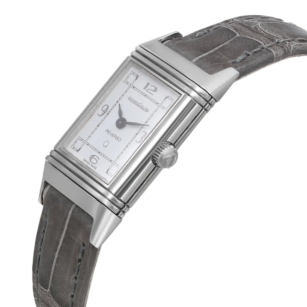 An image of a pre-owned wristwatch captured in a side profile view, showcasing the crown prominently. The watch features a rectangular face with a silver-tone case and a leather strap. The angle highlights the intricate details of the watch's design, emphasizing its classic and elegant appearance. The image is taken from a close distance, allowing clear visibility of the crown and the watch's craftsmanship.