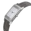 An image of a pre-owned wristwatch captured in a side profile view, showcasing the crown prominently. The watch features a rectangular face with a silver-tone case and a leather strap. The angle highlights the intricate details of the watch's design, emphasizing its classic and elegant appearance. The image is taken from a close distance, allowing clear visibility of the crown and the watch's craftsmanship.