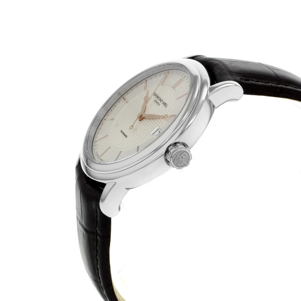 An image of a Wristwatch by RAYMOND WEIL. This Pre Owned item is designed for Men, featuring a Dress/Formal style. It has a Quartz movement and an Analog display with a Silver dial color. The indices include 12-Hour Dial,Non-Numeric Hour Marks. The band is made of Leather and the case is made of Stainless Steel. The watch has a Round shape with a case size of 39 mm and a case thickness of 8 mm.