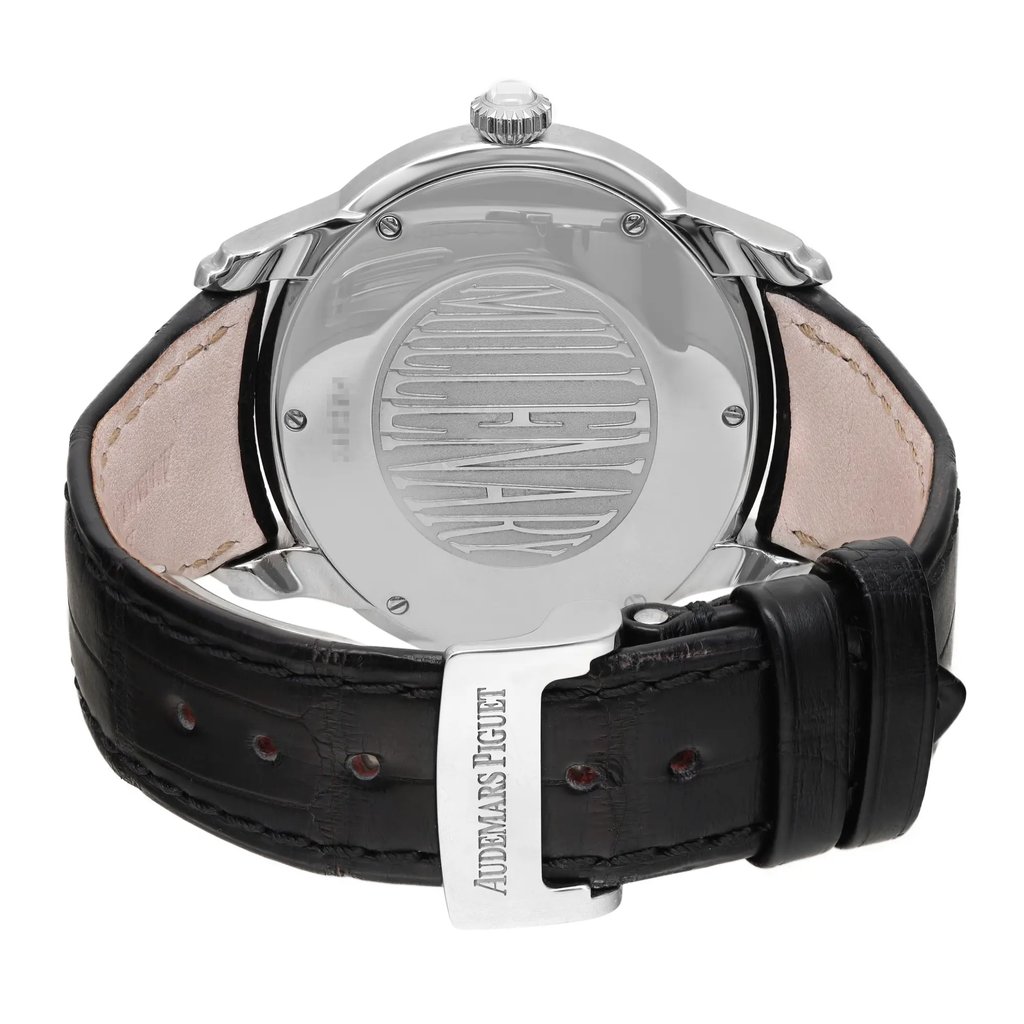 An image of a pre-owned wristwatch viewed from the back, showcasing the closed clasp. The angle is directly from behind, providing a clear view of the watch's polished metal back and engraved details. The black leather strap is visible, with a focus on the clasp, which is engraved with the brand name. The image is taken at a close distance, highlighting the texture of the leather and the sheen of the metal components.