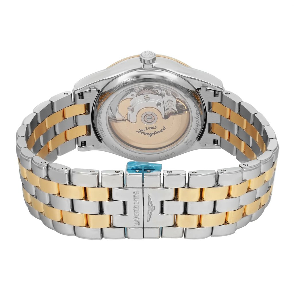 An image of a pre-owned Longines men's wristwatch, viewed from the back showing the exhibition caseback and the closed double-locking fold-over clasp. The watch is positioned with the clasp in the foreground, angled slightly to the left, with the caseback visible in the upper half of the frame. The stainless steel case and band feature gold-tone accents, which display micro scratches indicative of use. The Longines logo and movement are visible through the transparent caseback. The image is taken at a close distance to show detail.