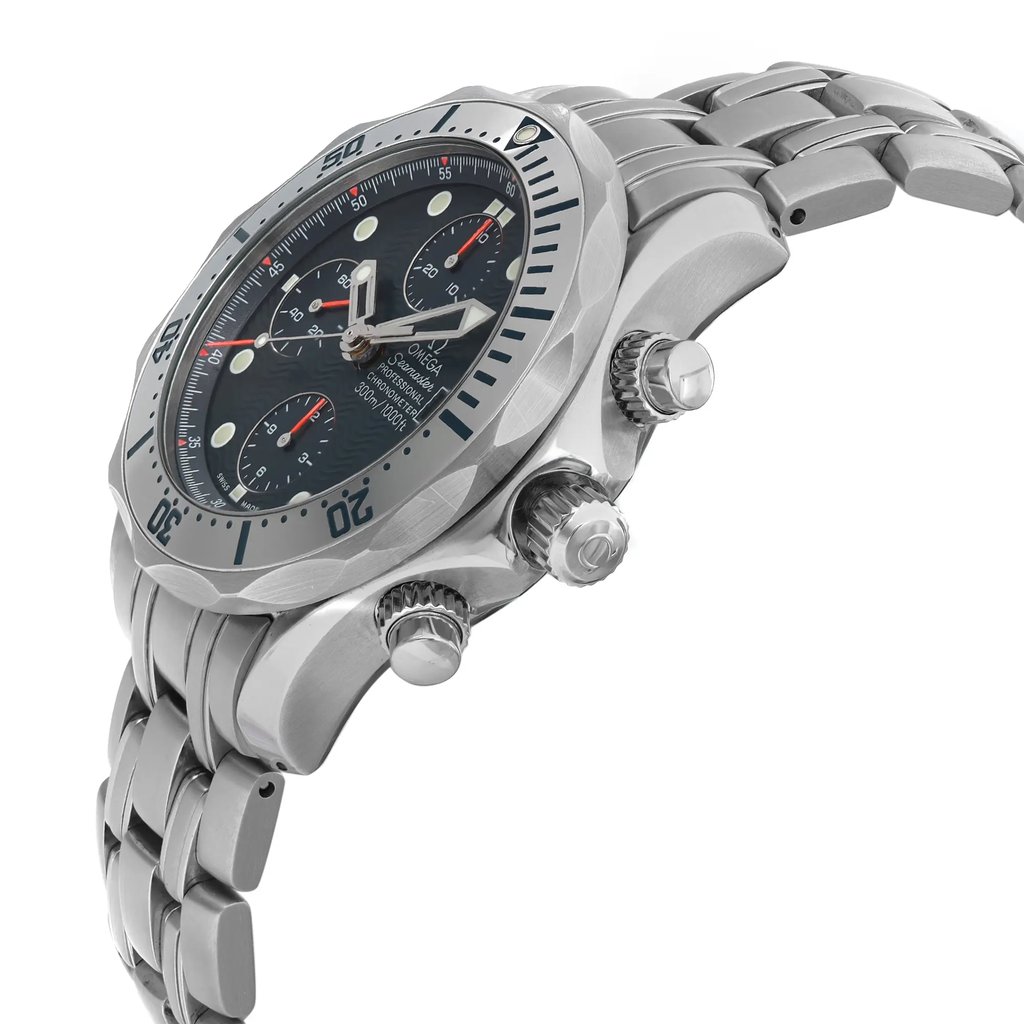 An image of a pre-owned OMEGA men's diver wristwatch showing a side profile view with the crown visible. The watch features a round stainless steel case and a matching band, positioned diagonally across the frame with a slight leftward tilt, emphasizing its depth and design. The watch has a blue dial, gray bezel, and includes chronograph functions, a date indicator, and luminous hands. The photograph is taken from a close distance to highlight the watch's details and craftsmanship. Light scratches on the bezel. Minor signs of wear on the watch