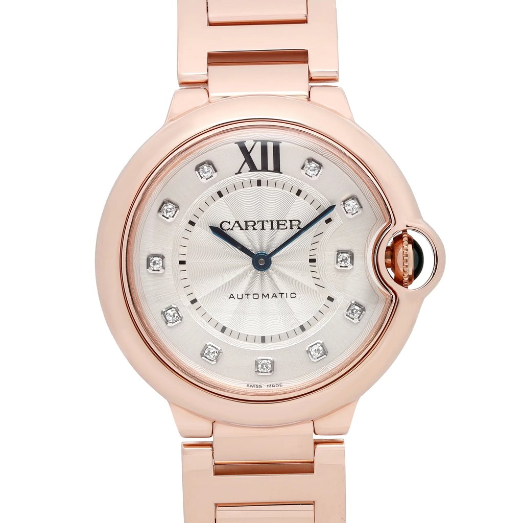 An image of a pre-owned Cartier women's luxury wristwatch in excellent condition. The photo is a front close-up shot capturing the watch face at a direct angle with the camera positioned at a close distance. The watch features a round rose gold case and band, a silver dial with blue hands, and diamond markers at the hours. The Cartier brand name and "AUTOMATIC" text are visible on the dial, along with the "Swiss made" designation at the bottom. The bezel color is also rose gold, and the watch has a 12-hour dial.