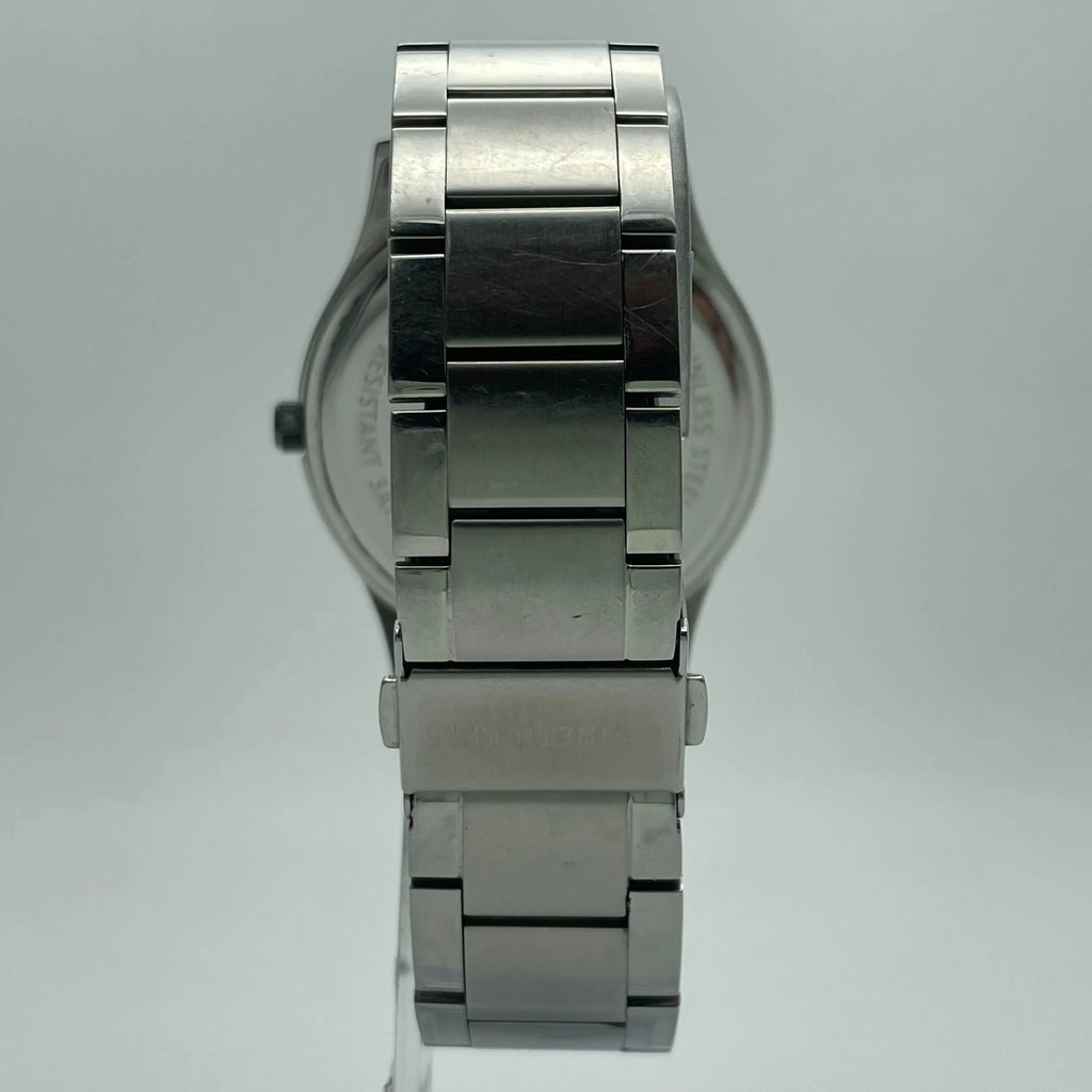 An image of a Wristwatch by Kenneth Cole. This Pre Owned item is designed for Men, featuring a Casual,Dress/Formal style. It has a Quartz movement and an Analog display with a Gray dial color. The indices include Stick Indexes. The band is made of Stainless Steel and the case is made of Stainless Steel. The watch has a Round shape with a case size of 44 mm and a case thickness of 10 mm.