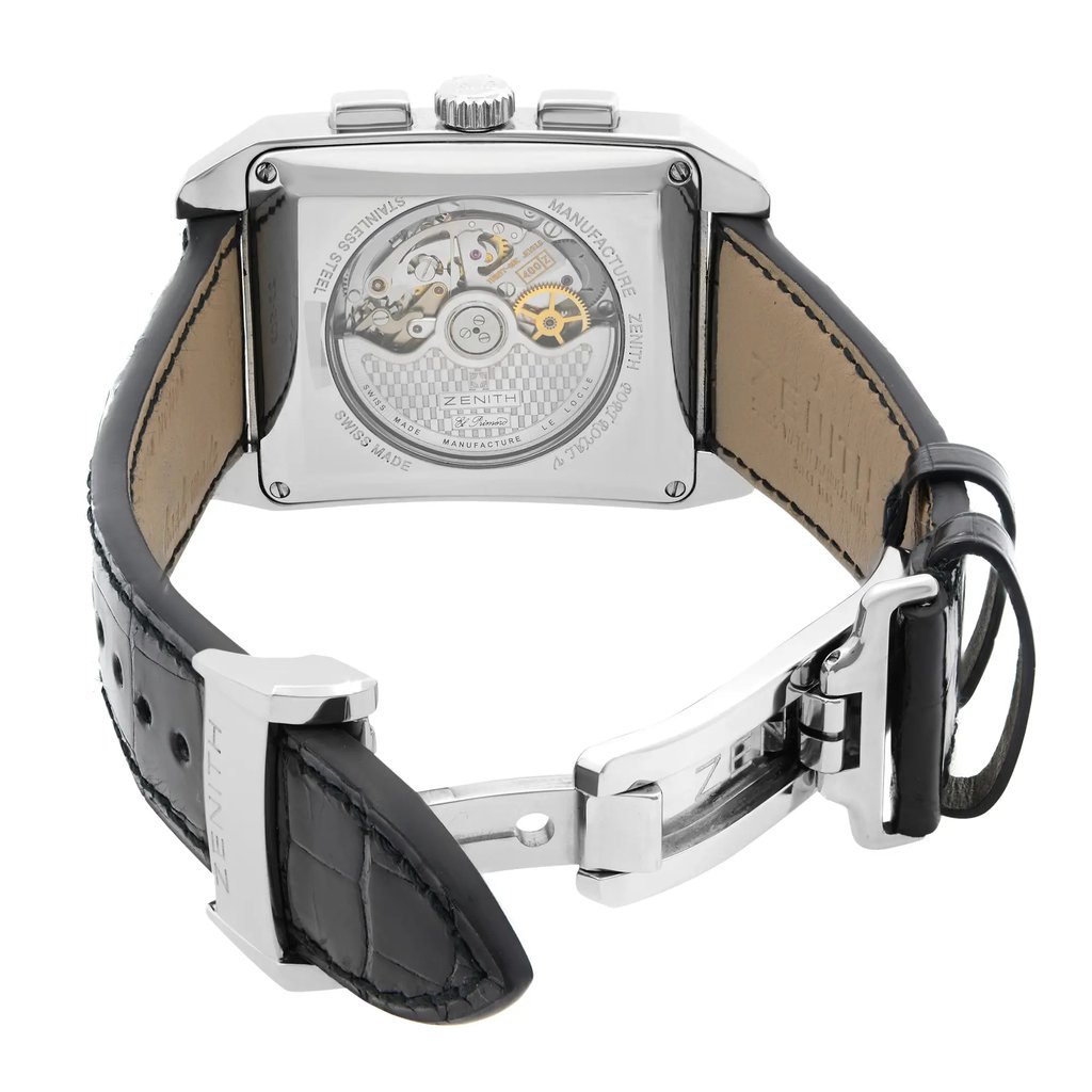 An image of a pre-owned wristwatch captured from the back view, showcasing its open clasp. The watch is positioned centrally, with a slight angle to highlight the transparent case back and visible mechanical movement. The clasp is open, allowing a clear view of the black leather strap's texture and the metal components. The image is taken from a moderate distance, focusing on the intricate details.