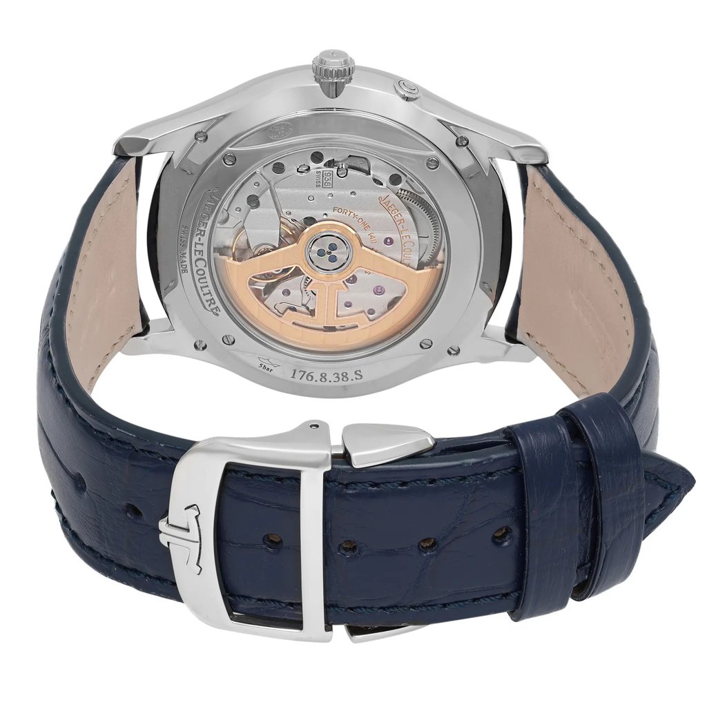 An image of a pre-owned wristwatch taken from the back view, showcasing the intricate mechanics through a transparent case back. The focus is on the detailed movement, with the clasp in the foreground, positioned centrally. The watch has a dark blue leather strap with a silver buckle, viewed from a close distance.