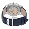An image of a pre-owned wristwatch taken from the back view, showcasing the intricate mechanics through a transparent case back. The focus is on the detailed movement, with the clasp in the foreground, positioned centrally. The watch has a dark blue leather strap with a silver buckle, viewed from a close distance.
