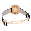 An image of a pre-owned Bvlgari women's wristwatch taken from the rear at a slight angle, showcasing the open clasp and the intricate back design. The watch has a gold-toned case with multicolored accents and a black leather strap, positioned centrally and viewed from a moderate distance to capture details.